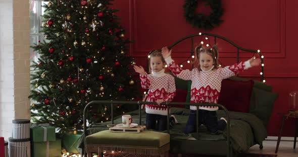 Two Pretty Girls Rejoices Together in Their Big Bedroom at Home