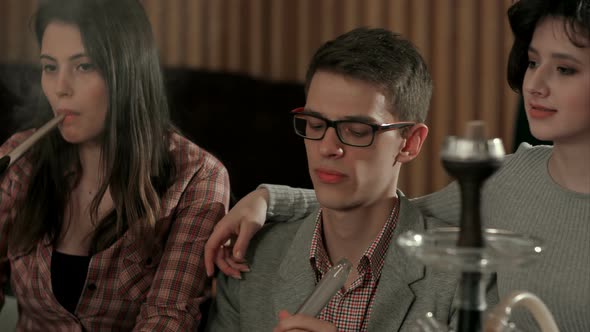 Group of Young People Smoking Hookah in the Lounge Caffee alt