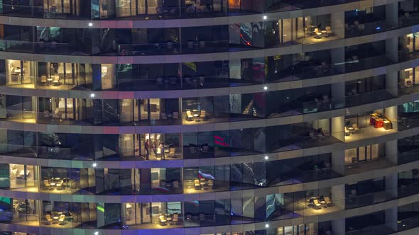 Outside View of Windows in Apartments of a High Class Building at Night Timelapse alt