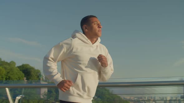 Motivated Sporty Fitness Black Man Jogging Outdoors at Sunrise alt