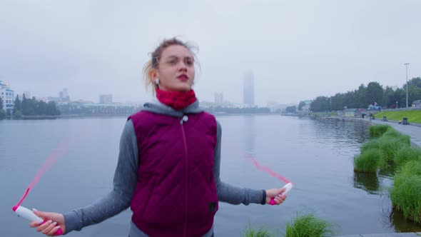 Slender Girl in Warm Sportswear is Jumping Rope alt