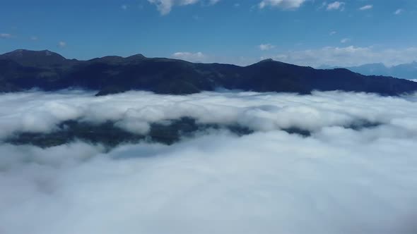 Dense clouds in the early morning light in the Alps of Austria. alt