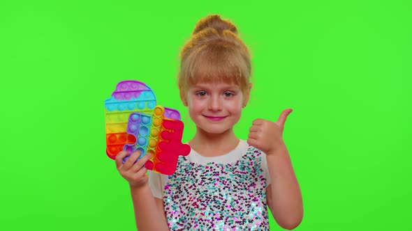 Child Girl Holding Many Colorful Squishy Silicone Bubbles Pop It Popular Sensory Toys Thumb Up alt