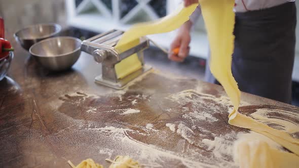 Chef's Hands Use a Pasta Cutting Machine