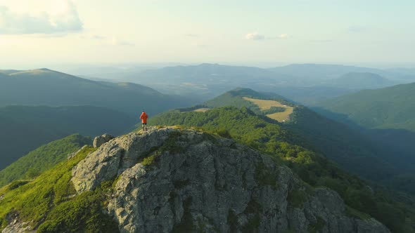 Single Male Hiker Walking on Rocky Edge Descending From Botev Peak Bulgaria alt