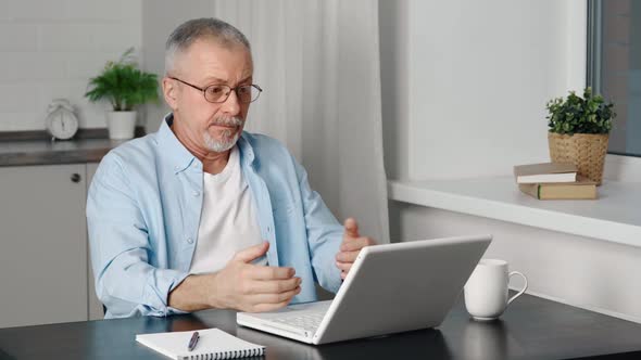 An Elderly Man is Outraged By News From the Internet or a Laptop Malfunction