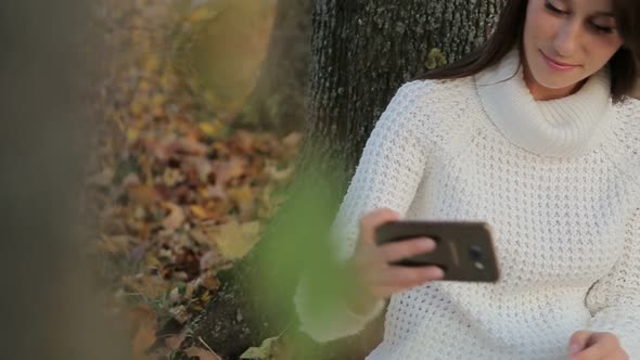 Girl Makes Selfie in the Autumn Park alt