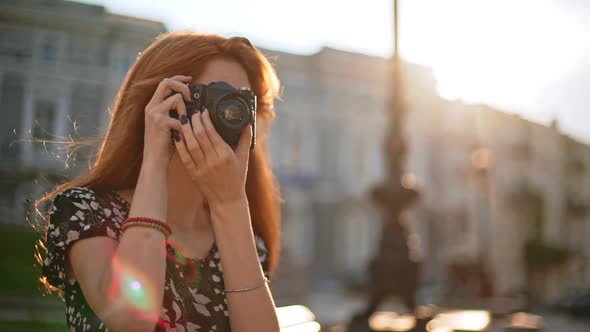Redhead Young Beautiful Girl Looking at Photo Camera Then Shooting in Slowmotion alt
