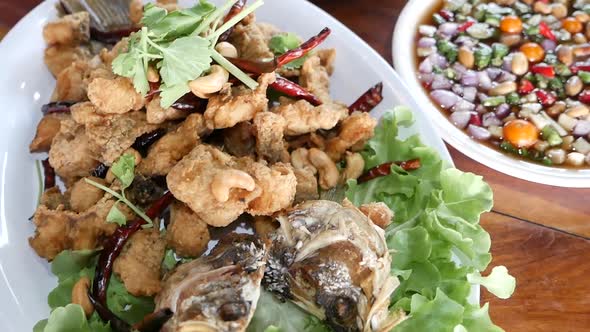 Close Up Footage of Thai Style Deep Fried Fish Served With Palm Sugar Sweet and Spicy Sauce (Miamg P alt