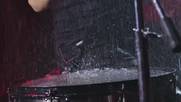 Drumsticks Bang on Wet Surface of Drum Water Splash and Splatter Rise Upwards in Slow Motion alt