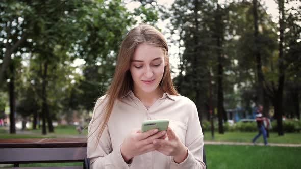Woman with smartphone surfing internet on mobile phone, checking email, reading media news. alt