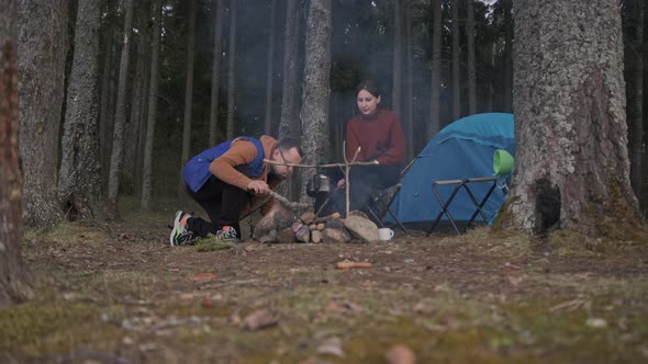 A Beautiful Cinematic Shot of Two Young Tourists a Man and a Woman in Wood alt