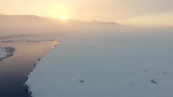 Flying low over the Salt River rising up through the fog at sunrise alt