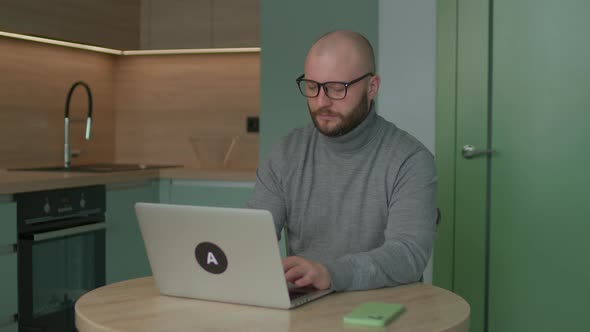 Young Adult Man Using Laptop alt