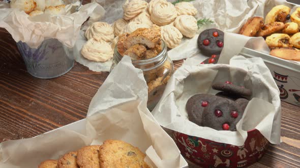 Wooden Table with Boxes of Various Tasty Cookies alt