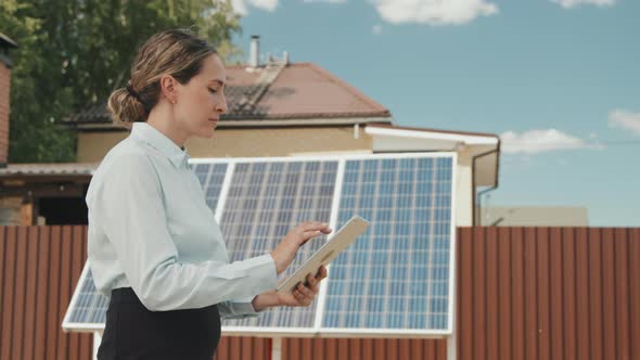 Woman Turning On Solar Panels alt