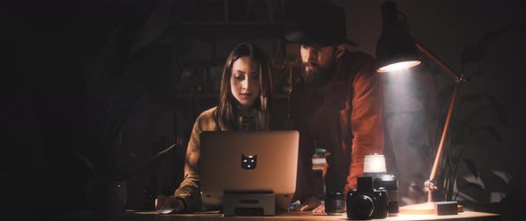 Man and Woman work together at desk alt