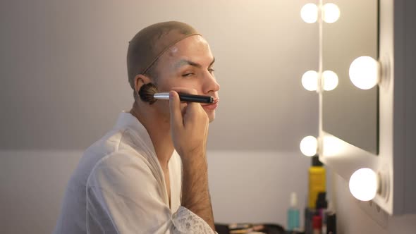 Side View Young Queer Woman Applying Face Powder Turning Looking at Camera Smiling alt