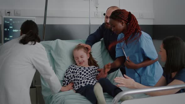 Sick Child Struggle While African American Nurse Trying to Check Heartbeat Pulse alt