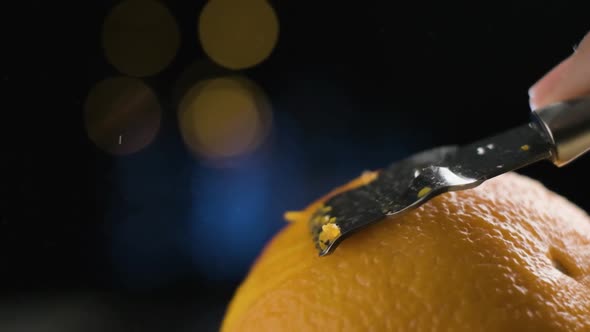Macro Shot Peeling citrus orange, oil particles being release in Slow motion, Blurred Background alt