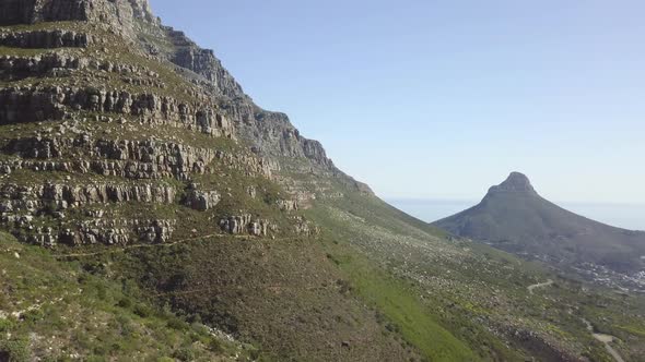 4K high quality aerial sunny blue sky footage of spectacular scenic Lion's Head Mountain, rocky hill alt