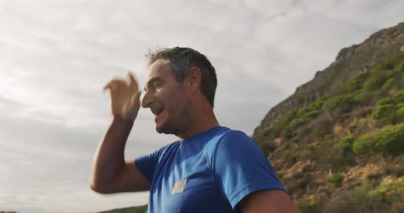 Man exercising outdoors taking a break alt