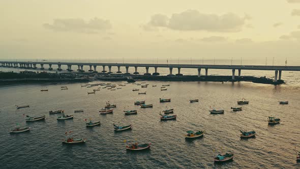 Aerial evening view of fishing boats sailing near Bandra Worli Sea Link in Mumbai, India. alt