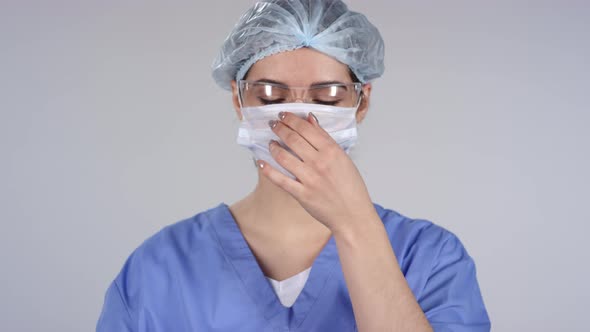 Female Medical Worker Putting on Mask alt