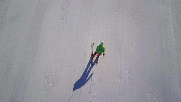 Top View Following Skier on Ski Slope With Drone