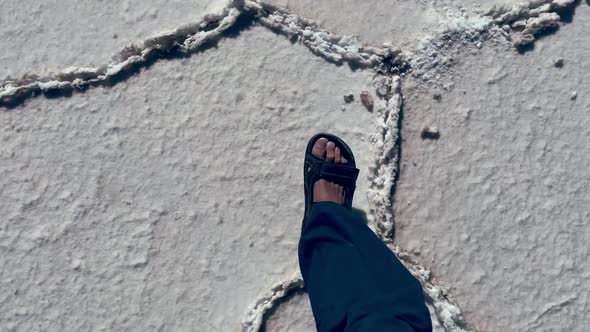 Male Feet Walking on Hexagonal Formations of Salar de Uyuni, Bolivia