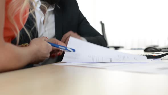 Couple (Man and Woman) Sign a Contract in the Office - Closeup Hands alt