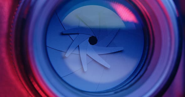 Adjusting Camera lens aperture with pink and purple light alt