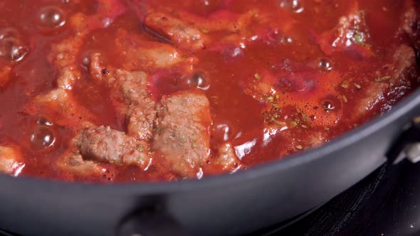 Cooking Beef Closeup in Tomato Sauce alt