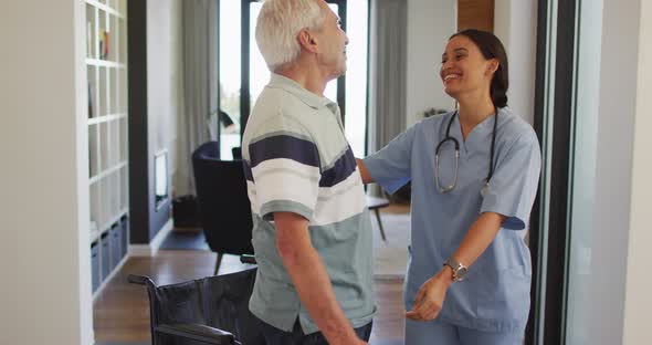 Animation of happy biracial female doctor taking care of caucasian senior man alt