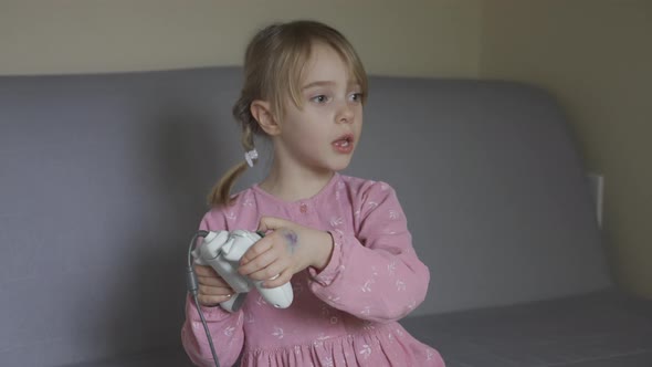 Little girl playing video games. alt