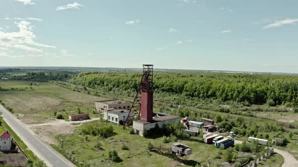 Aerial Wiev: Old Abandoned Salt Mine Against the Background Forest Wide Shot alt