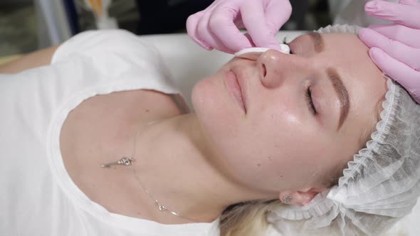 Portrait of a Woman During a Cosmetic Procedure
