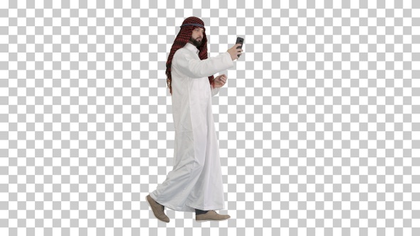 Arabian man walking and making a selfie, Alpha Channel alt