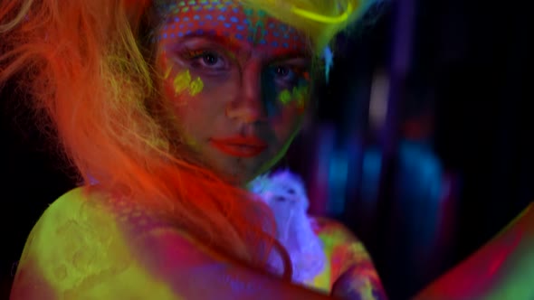 Young Woman with Fluorescent Makeup on Face and Bodyimage for Halloween alt