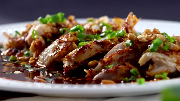 Chinese spicy chicken served in a plate and chopsticks