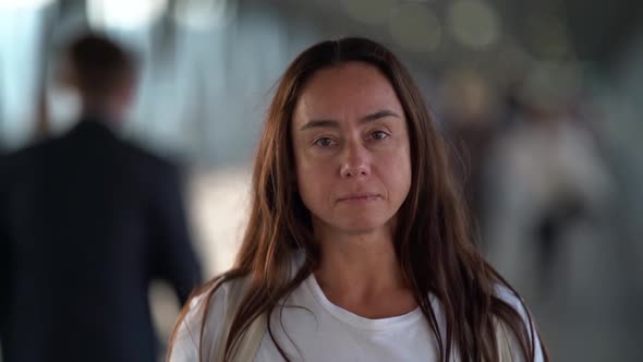 Portrait of Serious Passerby Woman in Public Place in City, Medium Shot alt