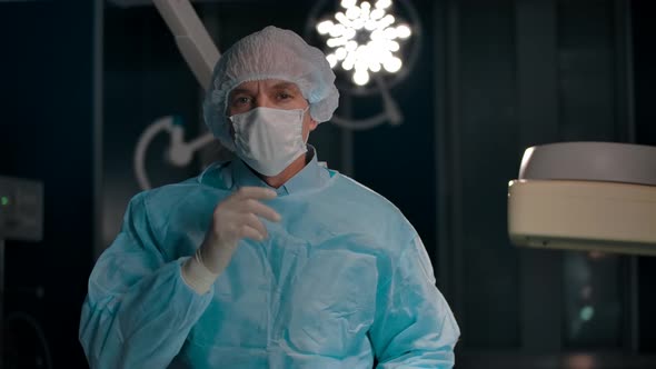 Portrait of a Surgeon Removing a Mask After a Successful Operation alt