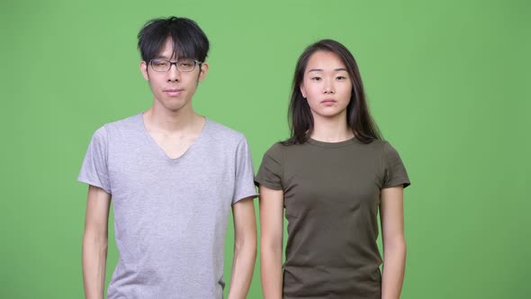 Young Happy Asian Couple Together with Arms Crossed