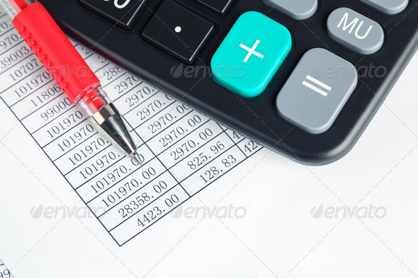 calculator and red pen - Stock Photo - Images