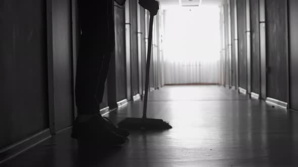 Unrecognizable Janitor Sweeping Floor alt