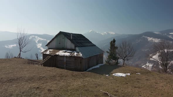 Village House on a Background of Winter Mountains