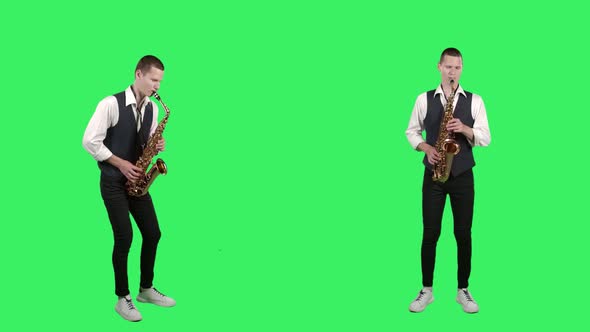 Portrait Stylish Young Guy Plays at Saxophone on a Green Screen in the Studio. Saxophonist alt