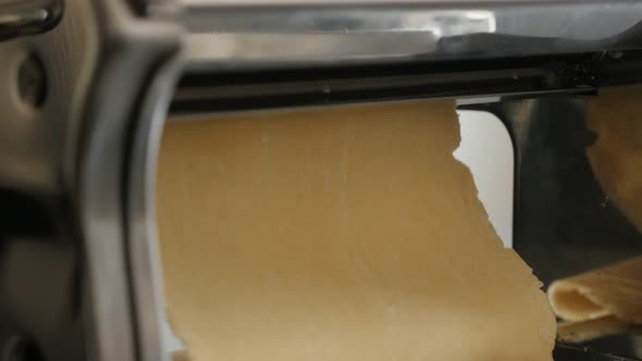 Pasta machine on the kitchen  table 4K 2160p 30fps UltraHD footage - Dough processing for Italian la alt