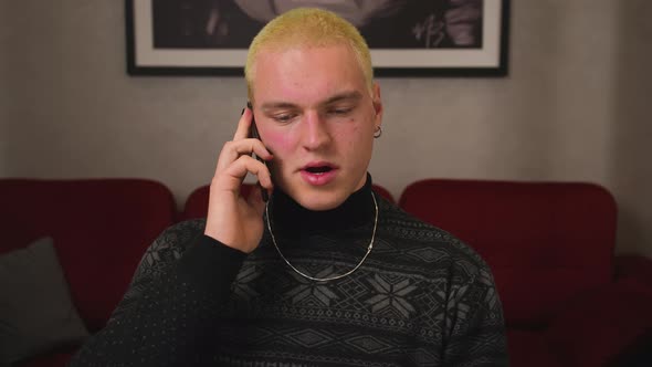 Close Up Homosexual Serious Man Talking Mobile Phone at Home alt