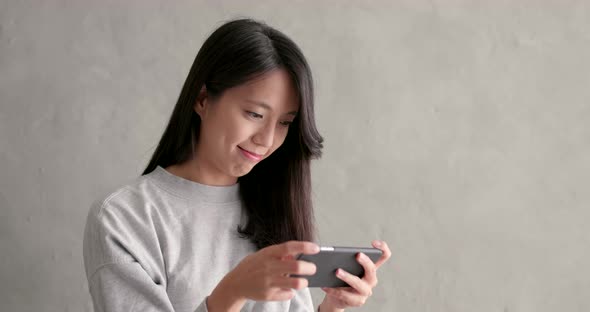 Woman use of smart phone over grey background alt